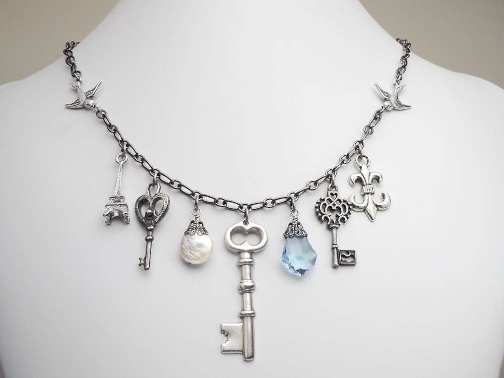 Antiqued silver charm necklace with genuine pearl blue swarovski crystal briolette eiffel tower and keys fleur de lis filigree swallow bird vintage