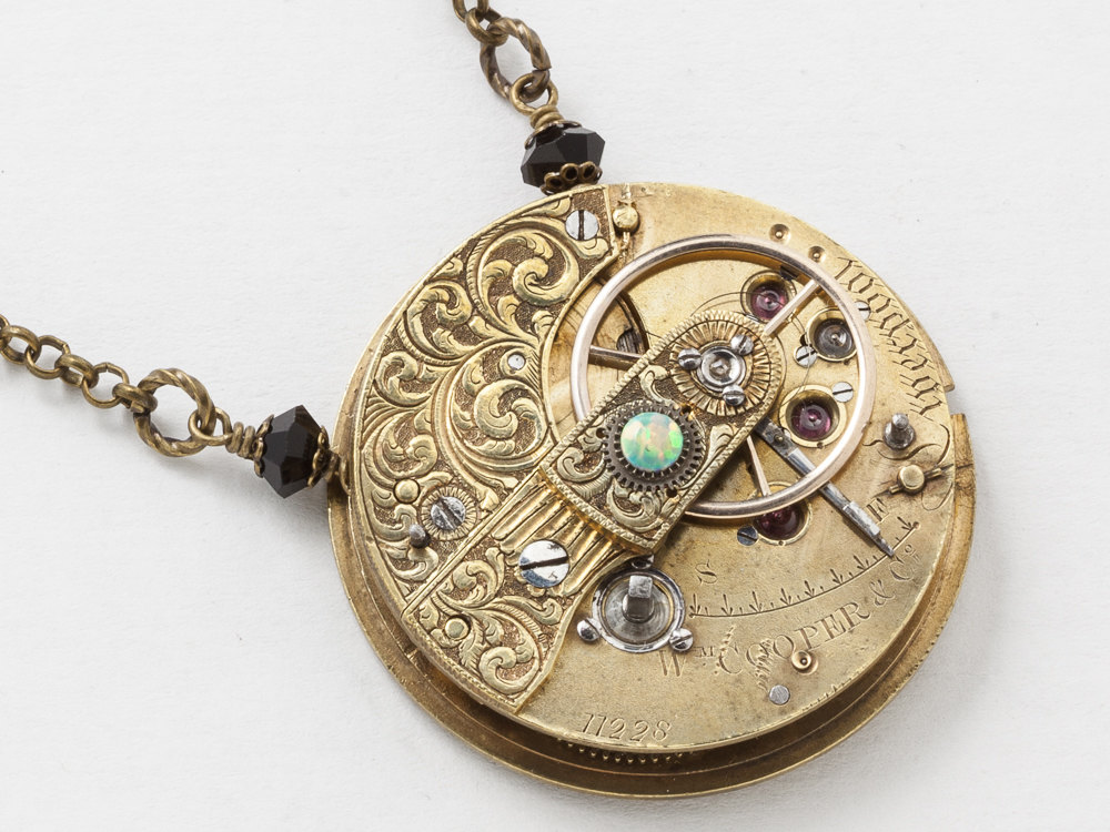 Steampunk Necklace featuring an Antique Victorian Fusee pocket watch movement with hand engraved gold leaf motif black crystal Opal stone